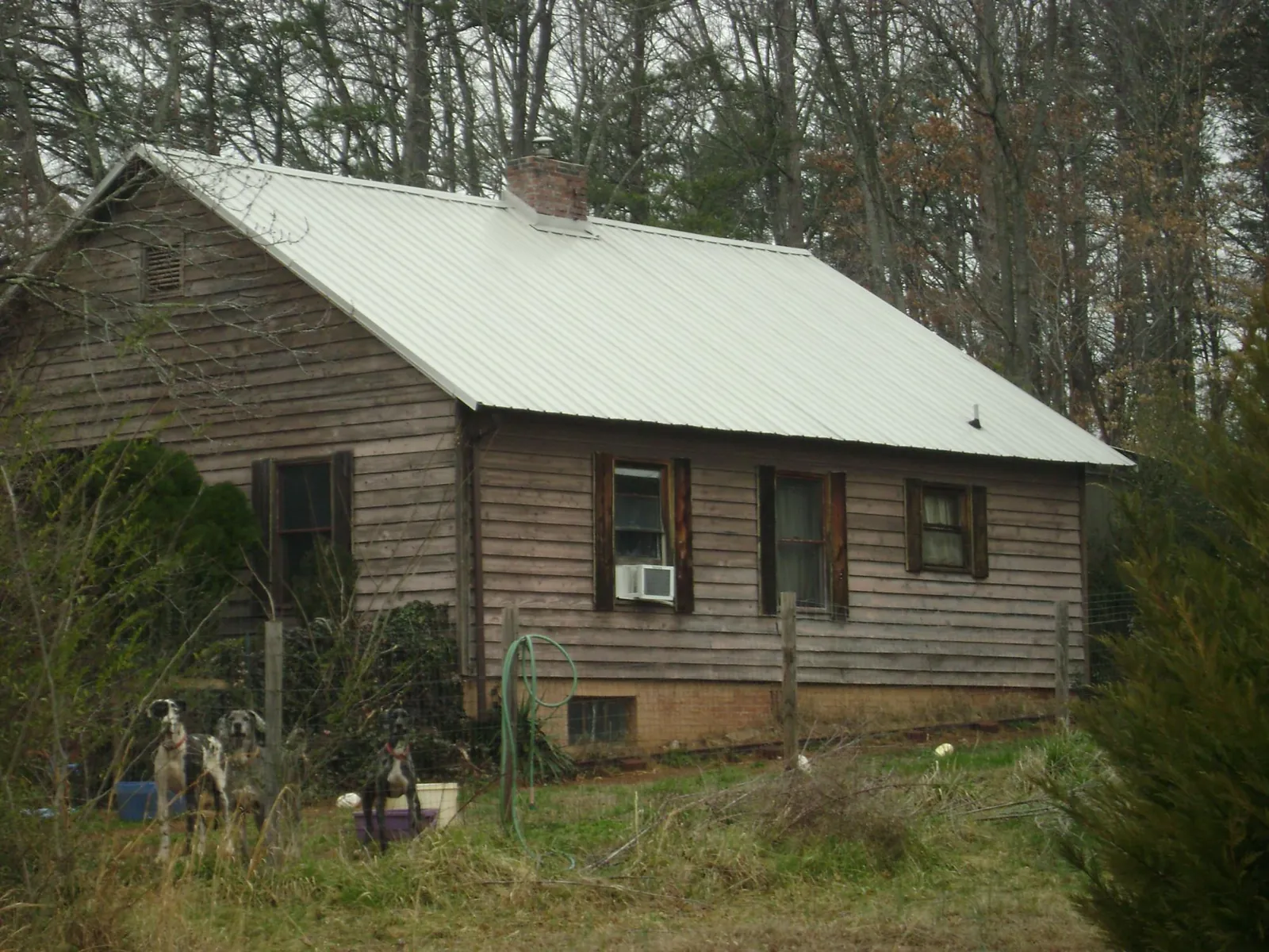 White metal roof on an old wood sided farmhouse, from a Metal Roof Installation job in Westminster
